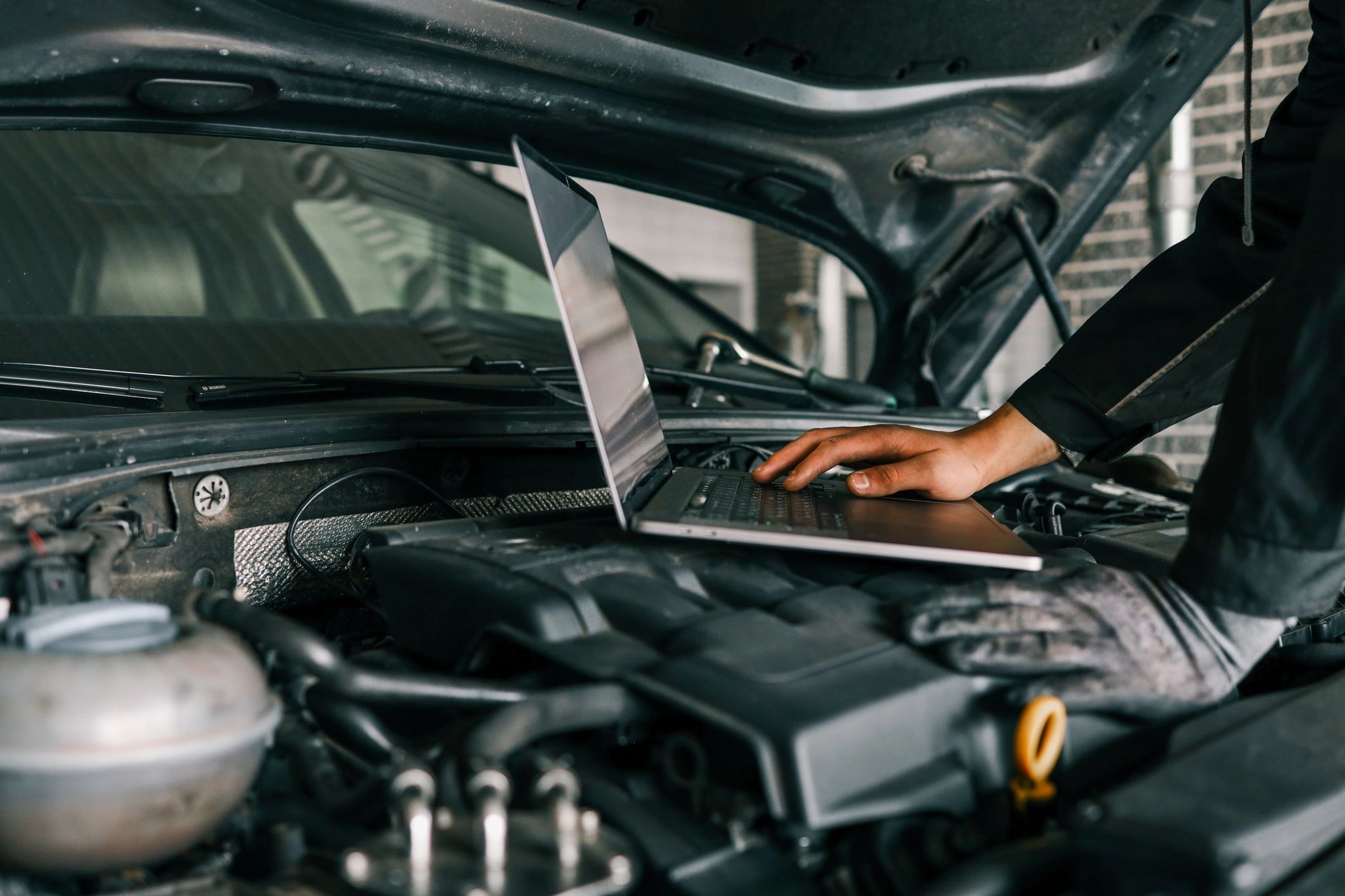 Mechanic working on car wheel with wrench