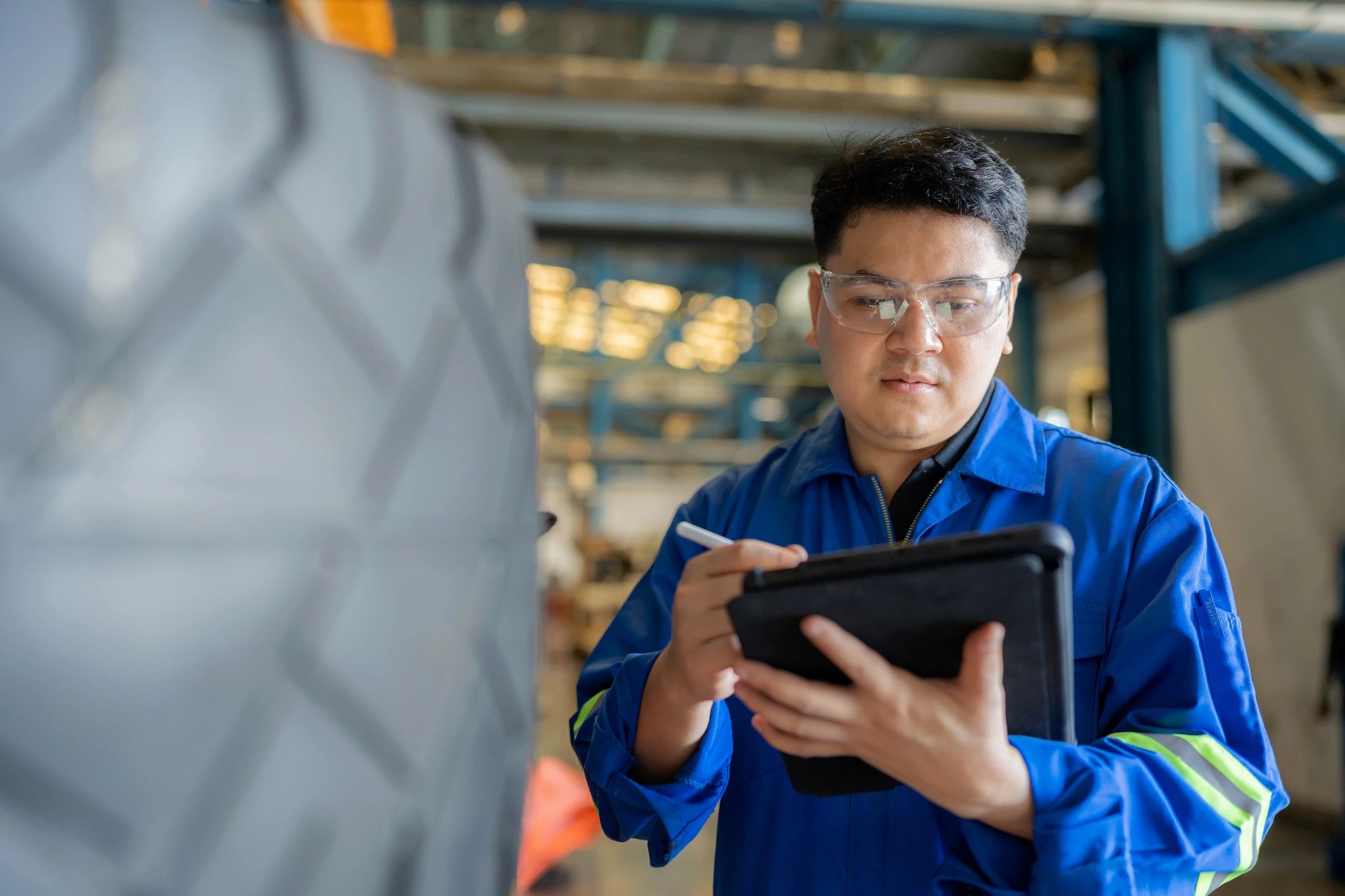 Technician inspecting tire in garage