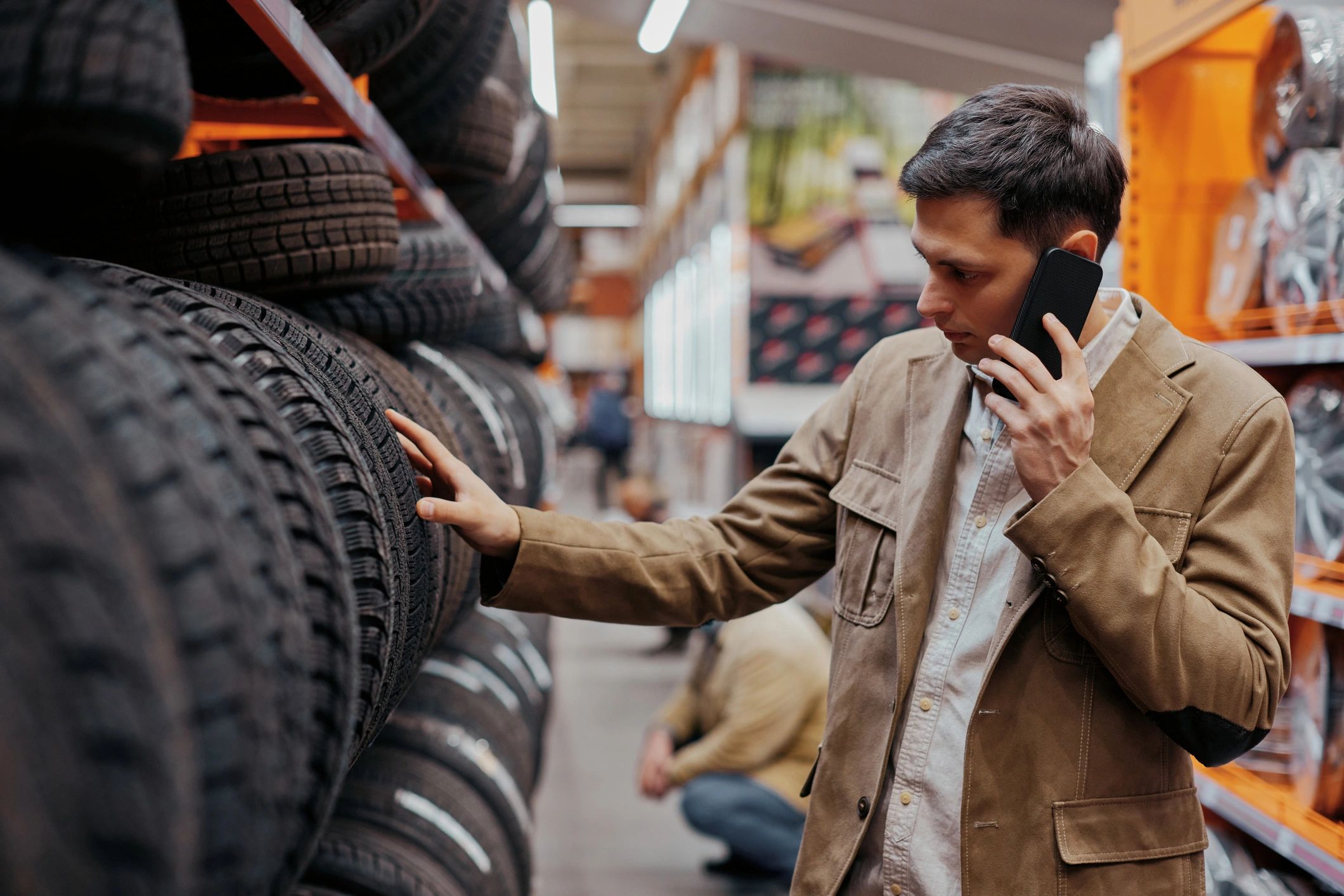Man examining tires in tire store