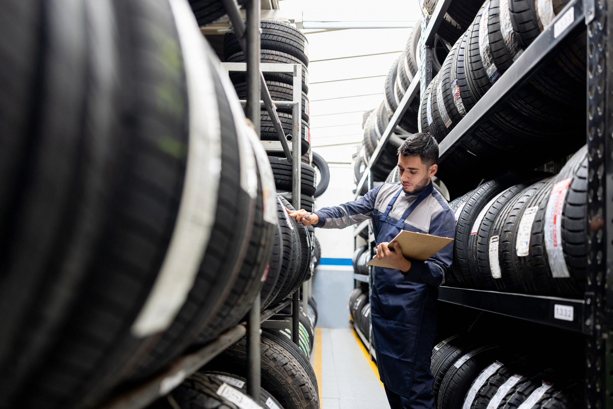 Warehouse worker inspecting tire inventory